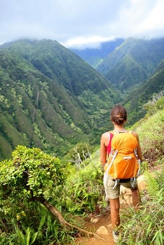 A young woman looks out over a valley.