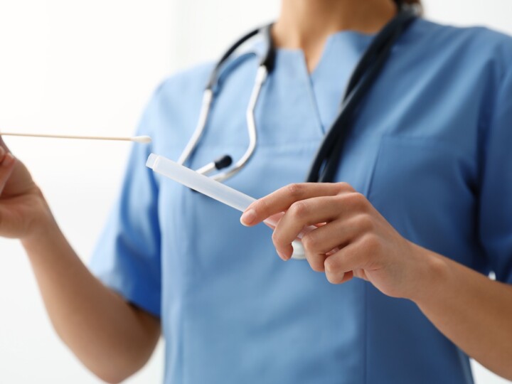 doctor holding buccal cotton swab
