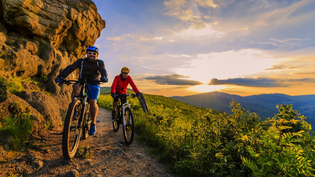 man and woman mountain biking