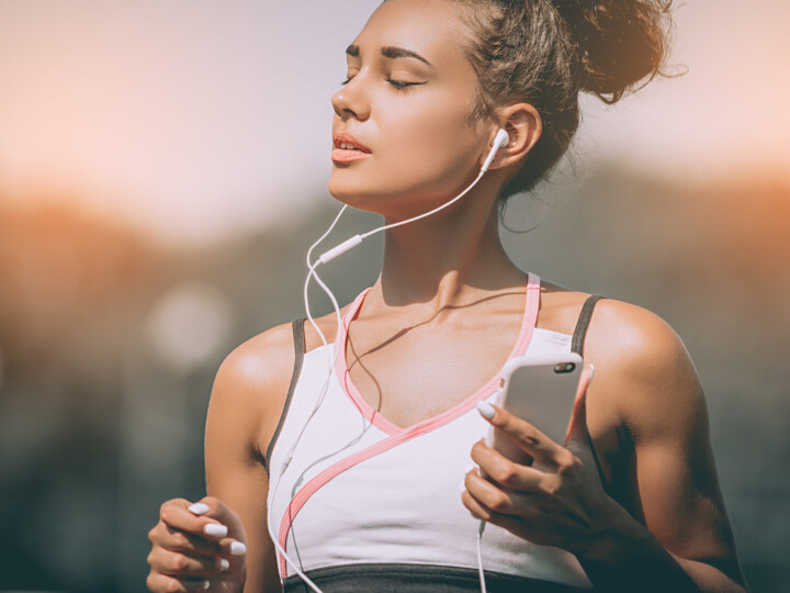woman jogging listening to podcast