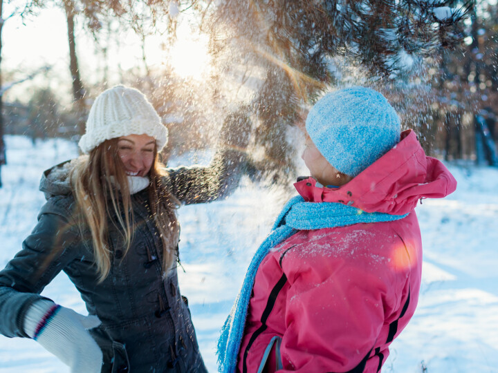 two people playing in the snow