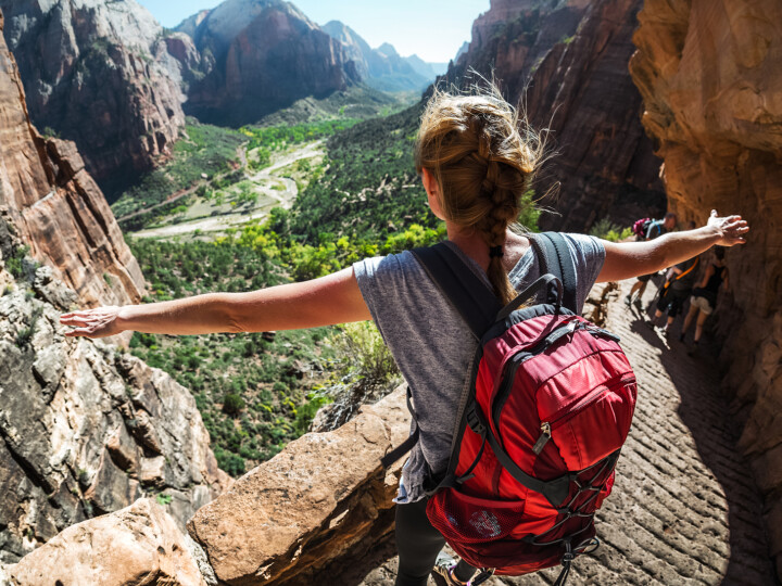 woman hiker standing near rails