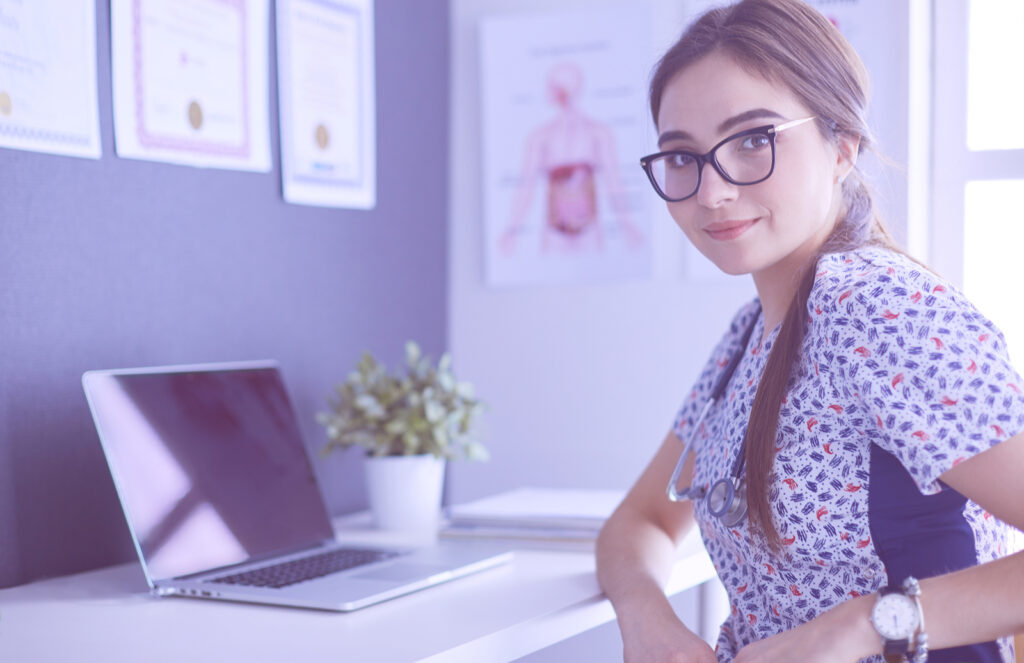 young travel nurse sitting in medical office