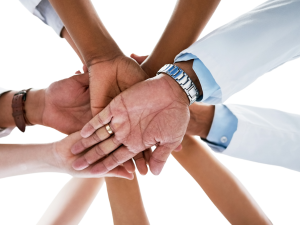hands overlapping in a circle showing support