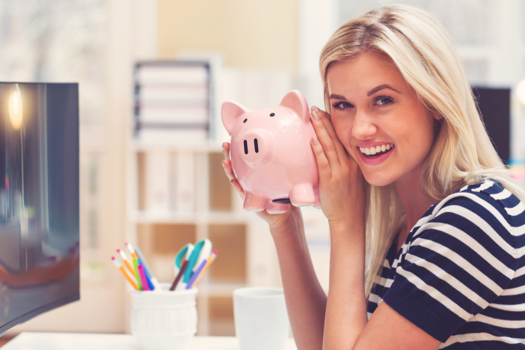 smiling lady holding piggy bank