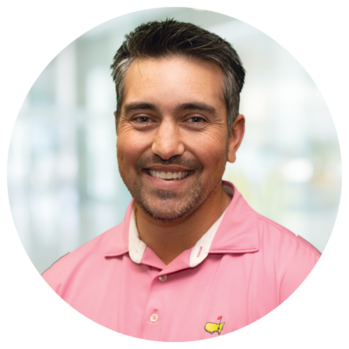 Jorge Magluta, Senior National Recruiter at Jackson Nurse Professionals, with short dark hair and facial hair, smiles in a pink collared shirt against a blurred indoor background.