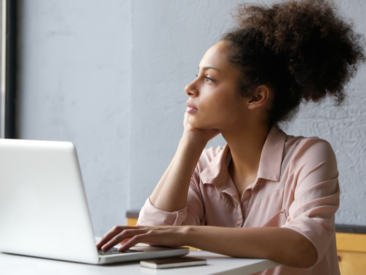 woman looking out window in deep thought