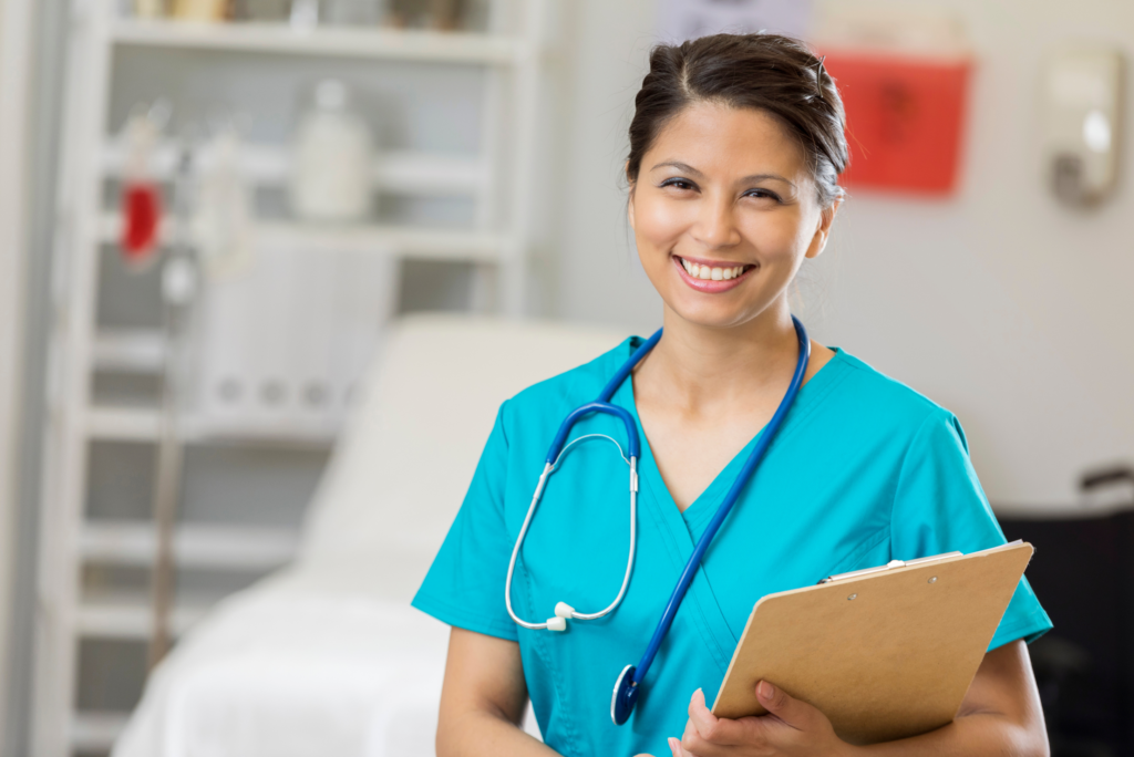 nurse smiling holding a clipboard