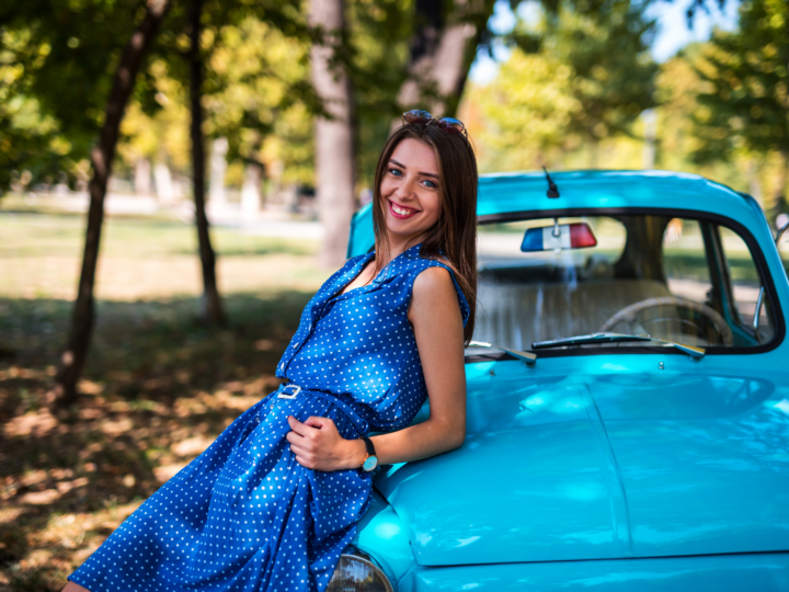 woman standing next to her car
