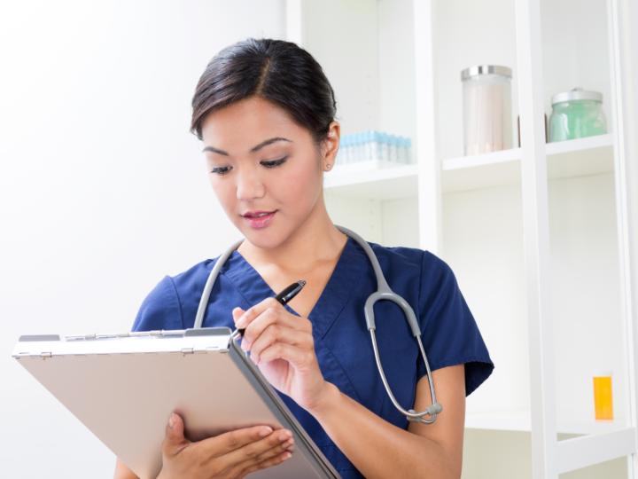 travel nurse writing in clipboard