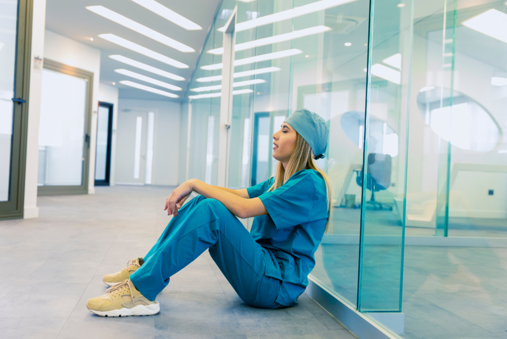 travel nurse sitting on floor