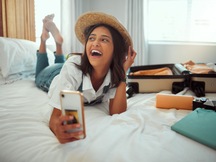 travel nursing girl on bed holding phone